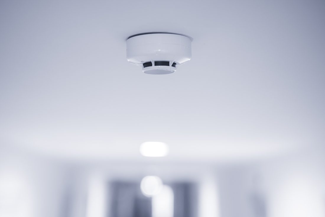 Smoke detector in a white room.