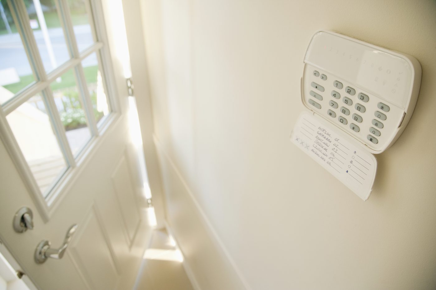 Security alarm monitoring system by a Long Beach property door.