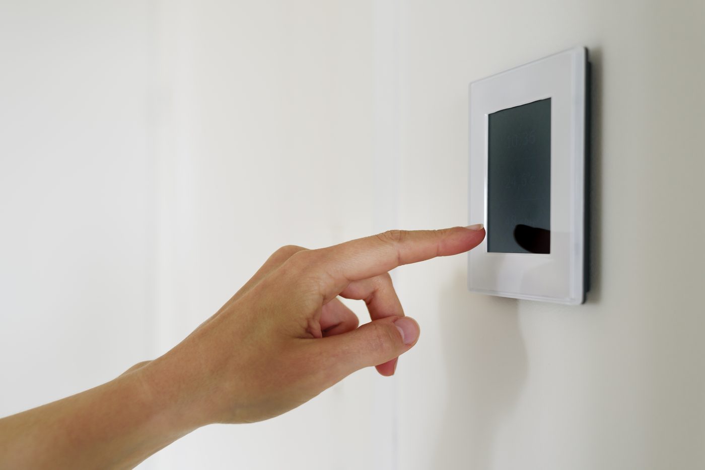 Person setting up a security system for monitoring a Pomona property.