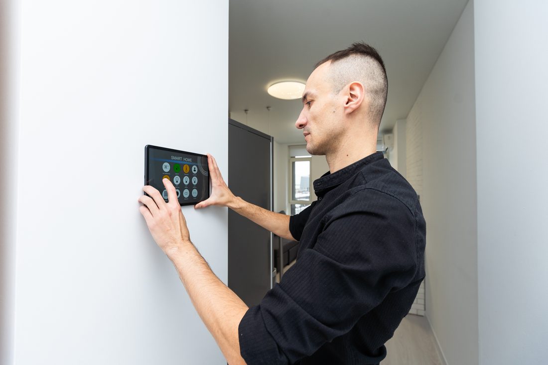Man operating a smart home alarm in Seal Beach.