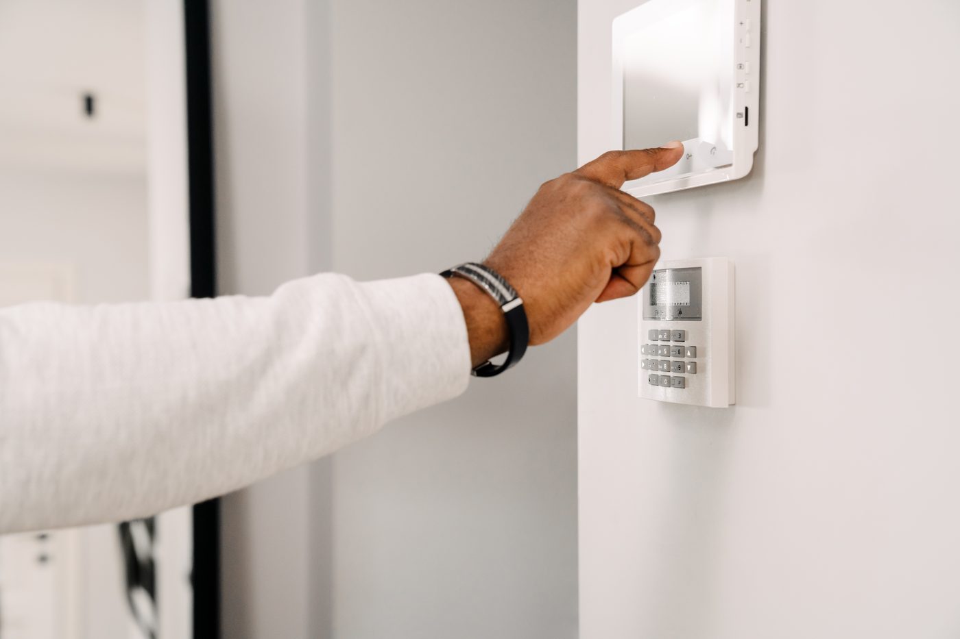 Hand operating security monitoring system in a Seal Beach property.
